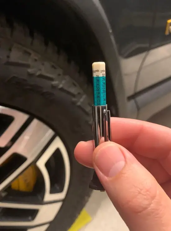 measure tire tread depth with gauge